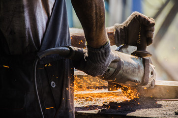  Worker grinding a metal plate.