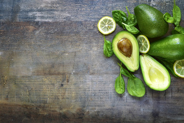 Ripe fresh organic avocado with spinach leaves and lemon slices. © lilechka75