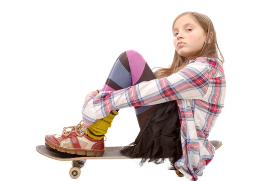  pretty young girl sitting on skate, on white
