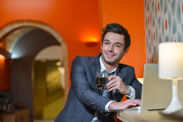 Handsome business man in restaurant drinking coffee 