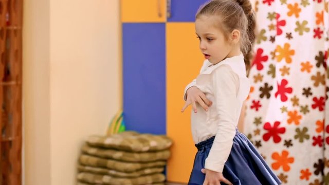Sweet little girl dancing in blue skirt. Slow motion