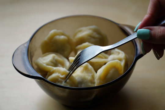 Woman Eating Meat Dumplings From Glassware