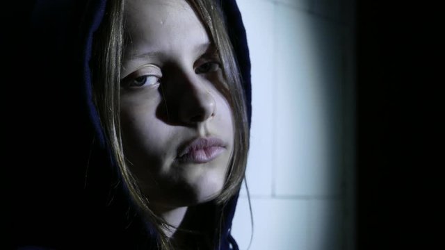 Teen girl. Drug addiction. Depressed face of a teen girl with overdose or hangover-abstinence syndrom from drugs. 4K UHD.