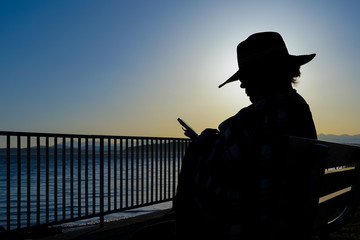 Female At Beach Sitting And Reading Silhouette