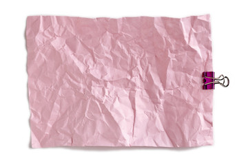 crumpled pink paper with binder clip