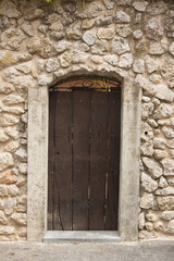 Fototapeta na wymiar Old door in the ancient stone house