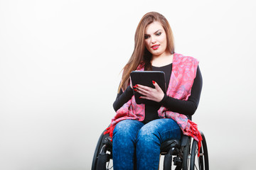 Young disabled lady with tablet.