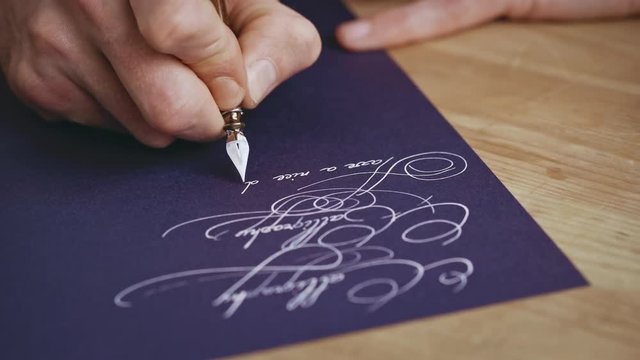 Writting letter with a pen. Calligraphy lesson. Close up. 