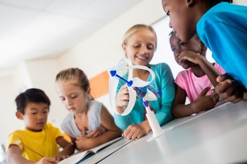 Smiling pupils using a wind turbine model 