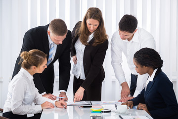 Businesspeople Analyzing Graph
