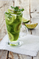 Glass of fresh fruit lemonade on white