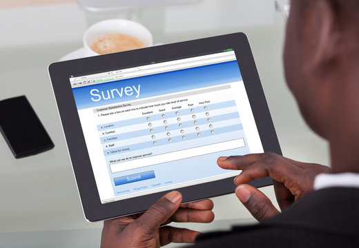 Businessperson Filling Survey Form On Digital Tablet