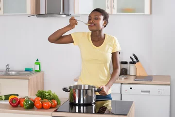Woman Cooking Meal In Kitchen