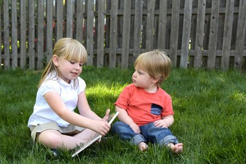 sister reading brother a book