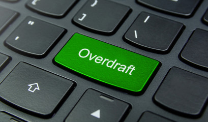 Business Concept: Close-up the Overdraft button on the keyboard and have Lime, Green color button isolate black keyboard