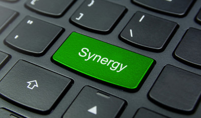 Business Concept: Close-up the Synergy button on the keyboard and have Lime, Green color button isolate black keyboard