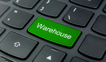 Business Concept: Close-up the Warehouse button on the keyboard and have Lime, Green color button isolate black keyboard