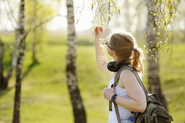 Beautiful woman with regard to branches of the trees.