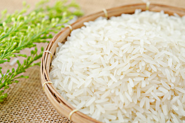 Raw white rice in wood basket.