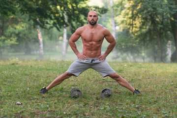 Stretching Exercise Outdoors Workout With Dumbbells