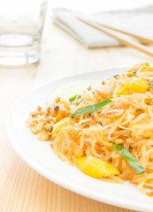 Pad Thai or Thai Fried Noodle on Wood Table with Napkin Chopstic