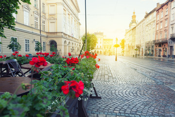 Street cafe terrace with tables and flowers