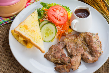Beef steak with black pepper sauce , salad and French fries on s