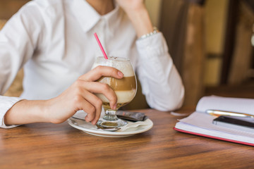 Fototapeta na wymiar Business woman drinking latte coffee in restaurant.
