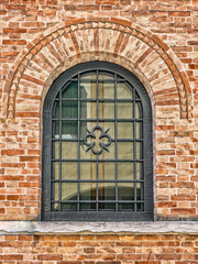 Decorated arched windows of a medieval building.
