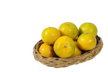 Thai orange in rattan basket isolated on white background.