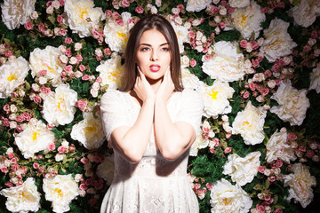 Beautiful woman in fashion light on flower background