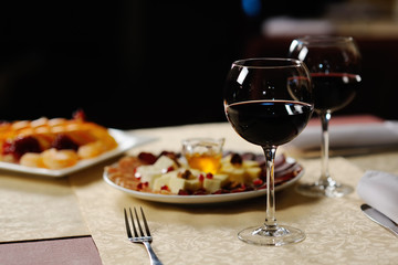 two glasses of red wine on the background of the dishes in the r