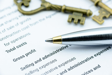 Blue ballpoint pen on an incorporation's income statement waiting for a financial Assistant Vice President (AVP) to review before submission to Chief Executive Officer (CEO). Financial concept.