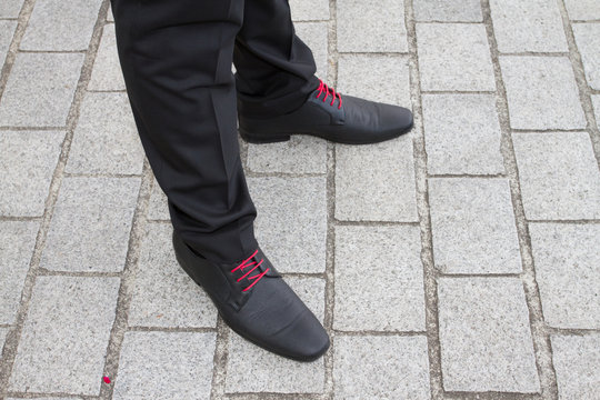 Close up image of man with  a red shoe lace.