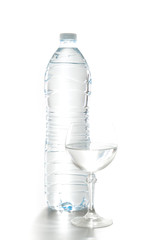 Glass of water with a bottle isolated on white