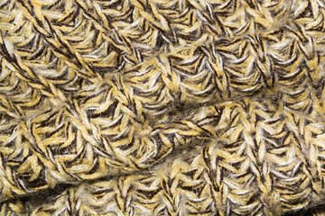 mottled diagonal texture of the wool yellow brown knitted fabric