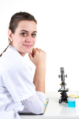 Female scientist looking through a microscope in laboratory