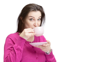 Pretty lady in pink drinking tea