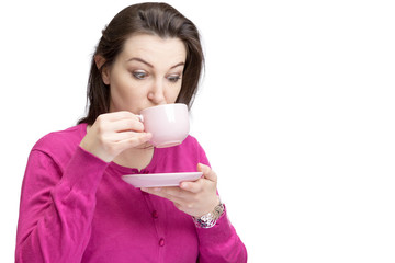 Pretty lady in pink drinking tea