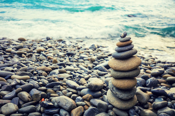 Stone tower on a pebble beach