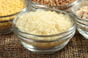various cereals in glass bowls on a burlap closeup
