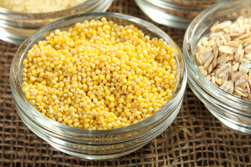 various cereals in glass bowls on a burlap closeup