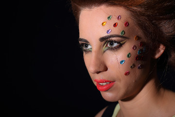 The beautiful girl with a hairdress and a make-up on a photoshoot in studio. In style a glamour....
