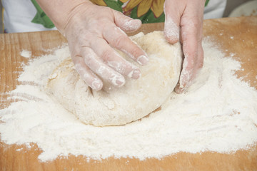Women's hands preparing fresh yeast dough