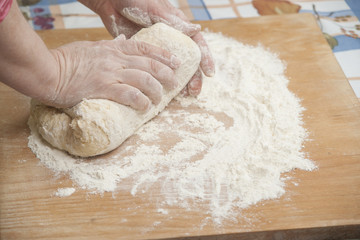Women's hands preparing fresh yeast dough