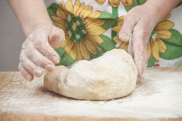 Women's hands preparing fresh yeast dough