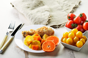 chicken drumstick cooked in spices with vegetables and citrus in