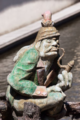 The water goblin statue guarding Velkoprerovsky Mill on Certovka or Devil's stream. Prague, Czech...