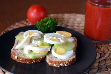 Healthy fresh homemade sandwich with eggs and cucumber with tomato smoothie