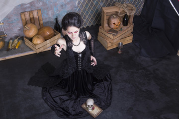 beautiful medieval gothic girl in long dress posing in studio